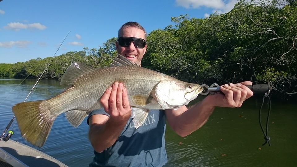 An angler holding a barramundi on the Endeavour River