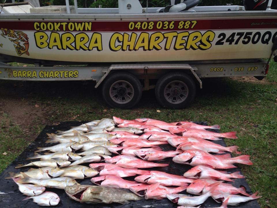 A day's catch laid out in front of the old signwritten boat