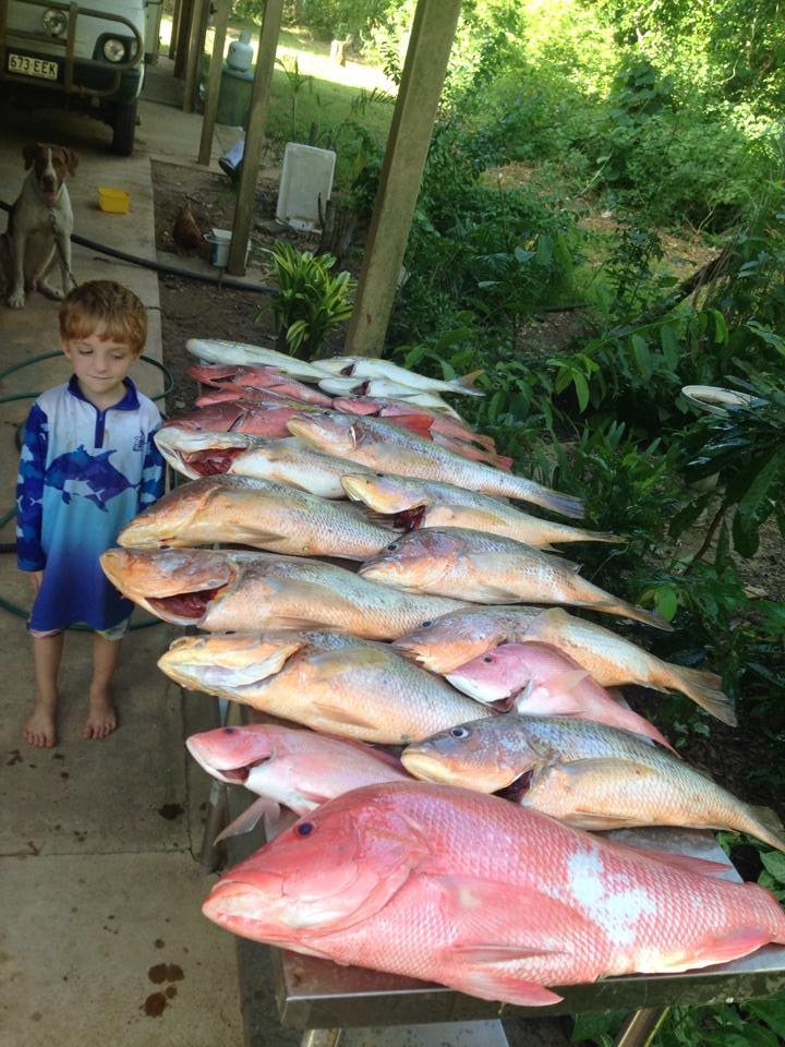 A young angler beside a bench of reef fish